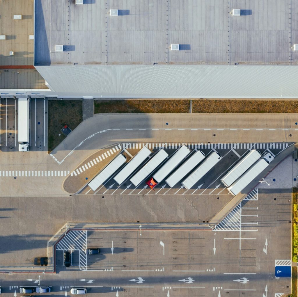 aerial shot of urban logistics centre with cargo trucks